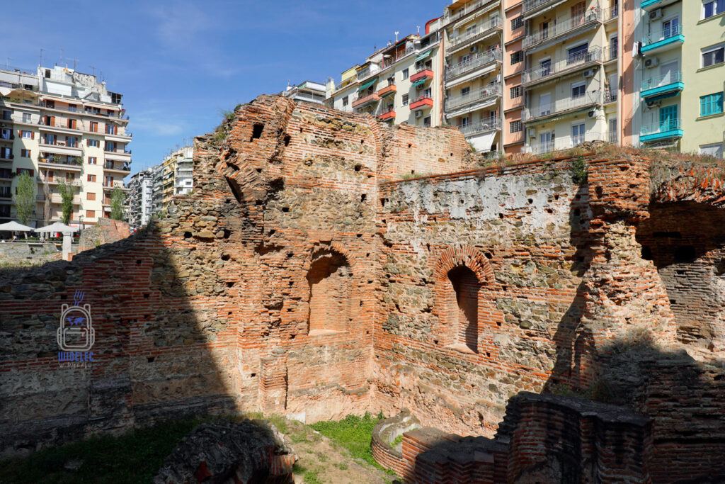 Ruiny pałacu Galeriusza w Salonikach na tle nowoczesnych bloków mieszkalnych, widok kontrastujący historię z codziennością